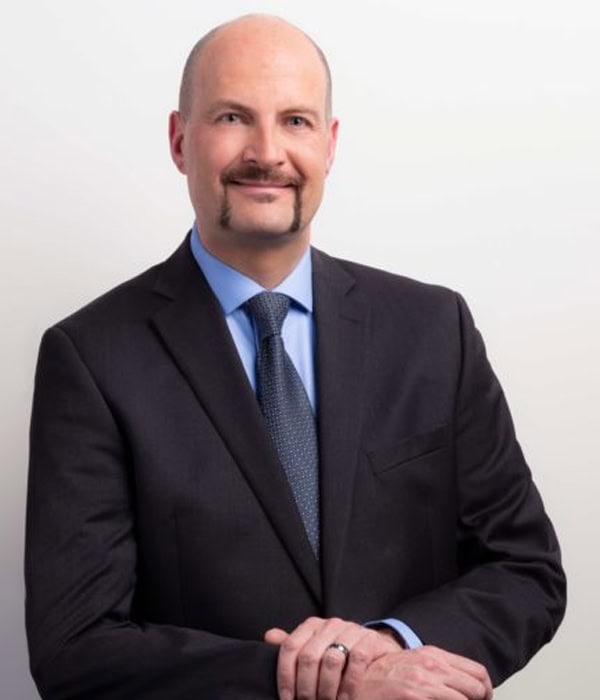 Professional portrait of Searle Starter, a member of the Board of Directors, dressed in a suit, representing leadership and governance.