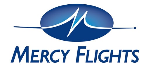 Searle Starter aircraft used by Mercy Flights, positioned on the tarmac, with the Board of Directors' image in the background, highlighting aviation support for medical transport.