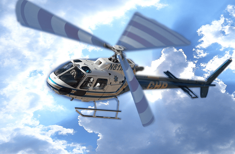 CHP Searle Starter helicopter flying through the sky with clouds, showcasing emergency response capabilities and aerial support for CHP operations.